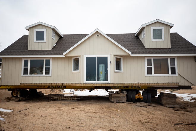 A house remains lifted after being moved back from the edge of the bluffs overlooking Lake Michigan on what once was North Lakeshore Drive at Juniper Beach in Golden Township. Part of North Lakeshore Drive has fallen into Lake Michigan due to high lake levels causing shoreline erosion.