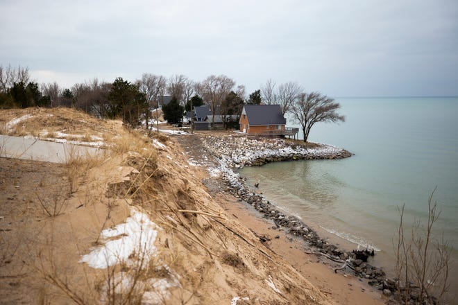A driveway drops off after the remainder of it has slid down the bluff on the edge of Lake Michigan  on what used to be North Lakeshore Drive at Juniper Beach in Golden Township. Part of North Lakeshore Drive has fallen into Lake Michigan due to high lake levels shoreline erosion.