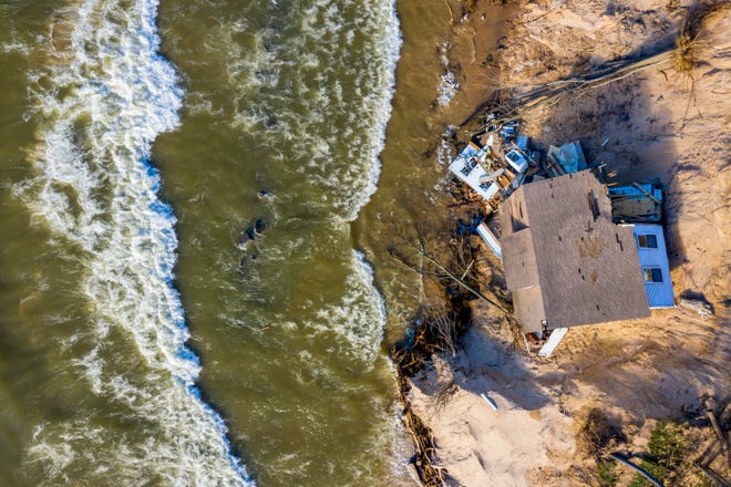 Lake Michigan erosion claims Patricia "Tish" Gancer's beach house, pictured on Thursday, Jan. 2, 2020, in White River Township, near Montague, Mich.
