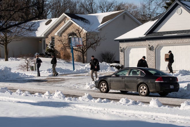 Law enforcement personnel leave the home of former U.S. Olympic women's gymnastics coach John Geddert, who had ties to disgraced sports doctor Larry Nassar, Tuesday, Jan. 21, 2020, in Grand Ledge.