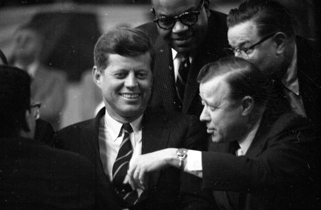 Presidential candidate John F. Kennedy and UAW President Walter Reuther talk during a campaign stop in March 1960.