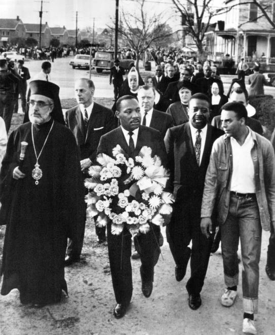 Dr. Martin Luther King Jr. carries a wreath on a march to the courthouse for memorial services in Selma, Ala. for the Rev. James Reeb in March 1965. Behind him is Walter Reuther, a longtime supporter of civil rights. It was Reuther who called for the first meeting in Washington D.C. in 1949 to discuss civil rights legislation.