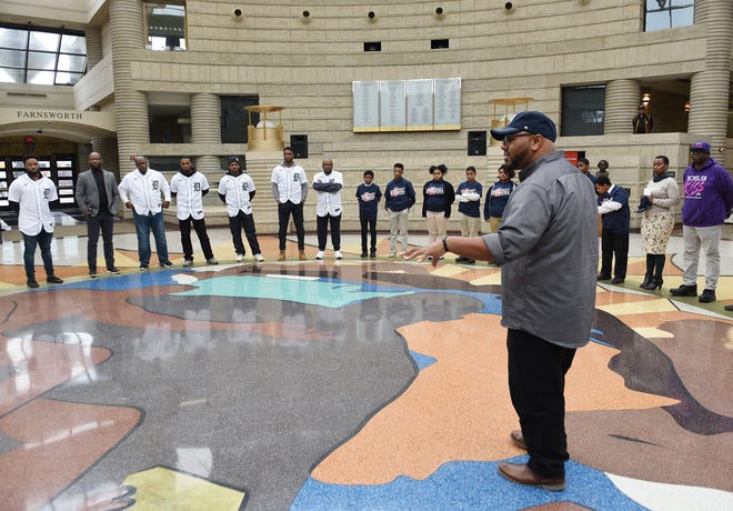 Tigers players and guests listens to museum educator Jonathan Jones as he gives them an introduction and history facts of the museum inside the rotunda.