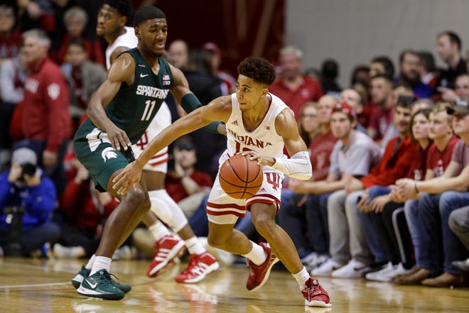 Indiana guard Rob Phinisee (10) drives around Michigan State forward Aaron Henry (11) in the second half.