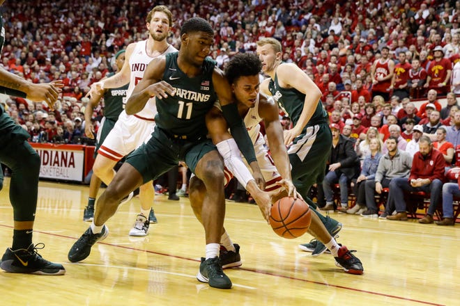 Michigan State forward Aaron Henry (11) and Indiana forward Justin Smith (3) go for a loose ball in the first half.