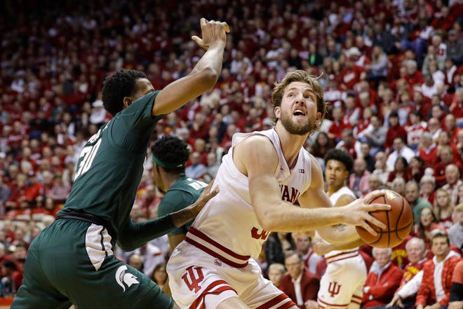 Indiana forward Joey Brunk, right, looks to shoot over Michigan State forward Marcus Bingham Jr., left, in the first half of an NCAA college basketball game in Bloomington, Ind., Thursday, Jan. 23, 2020. Indiana won the game, 67-63.