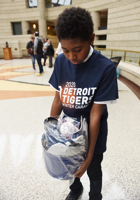 Christian Polk, 13, of Detroit inspects the gift bag of baseball gear he received from the Tigers after their tour of  the Charles H. Wright Museum of African American History.