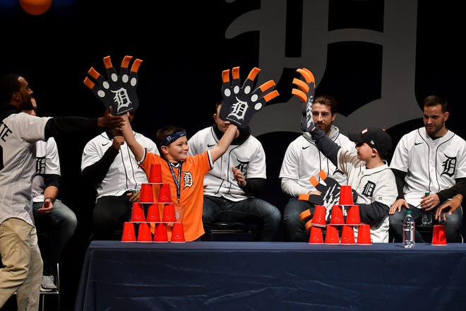 Matthew Biggs, 9, of Taylor, left, reacts after defeating Domonic Hamden, 10, of St. Clair Shores in a race to make a tower of plastic cups while wearing giant Tigers claw hands during the Tigers' Winter Caravan Kids Rally at Lake Shore High School in St. Clair Shores, Mich. on Friday,  Jan. 23, 2020.