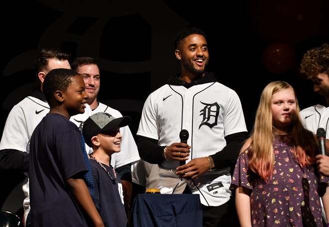 Tigers infielder Niko Goodrum smiles while, from left, Justin Myricks, 11, of St. Clair Shores, Liam Colins, 9, of Holland and Layla Breault, 9, of St. Clair Shores play a trivia game during the Tigers Winter Caravan Kids Rally at Lake Shore High School in St. Clair Shores.