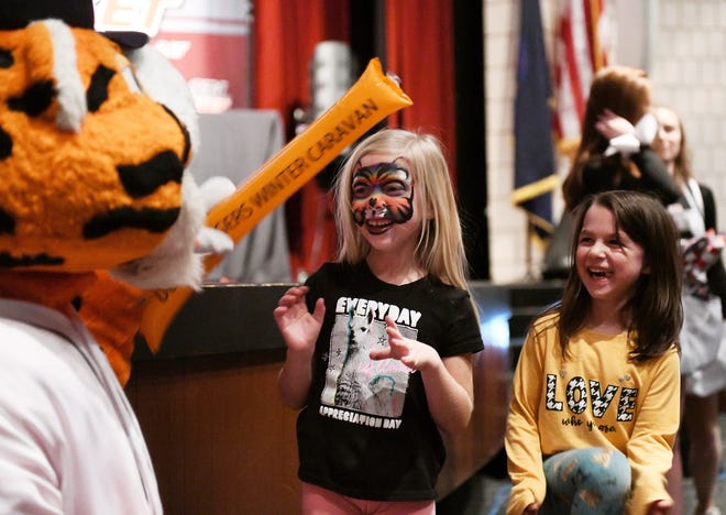 Paws plays with (from left) Reese Kuhle, 6, and Caroline Smith, 6, both of St. Clair Shores at the Tigers Winter Caravan Kids Rally at Lake Shore High School in St. Clair Shores Thursday.