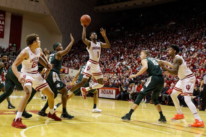 Indiana guard Al Durham (1) shoots between Michigan State guard Cassius Winston (5) and forward Thomas Kithier (15) in the first half.