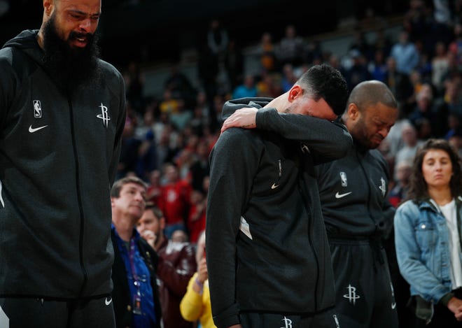 From left to right, Houston Rockets center Tyson Chandler, guard Austin Rivers and forward P.J. Tucker react during a tribute to Kobe Bryant before a game Sunday.