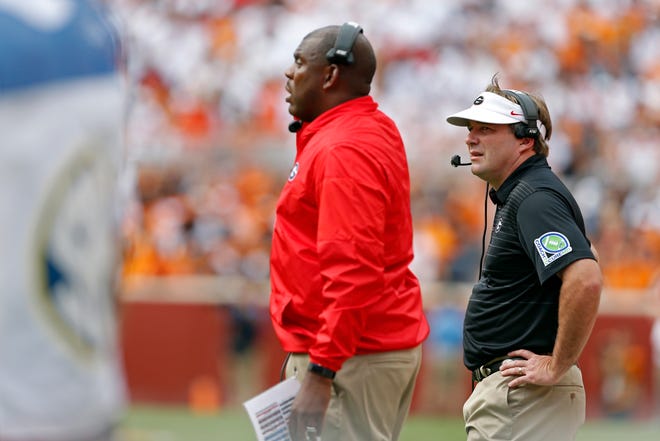 Georgia head coach Kirby Smart watches as assistant coach Mel Tucker calls a play during the first half of an NCAA college football game Sept. 30, 2017, in Knoxville, Tenn. Tucker was an assistant at Georgia from 2016-18.