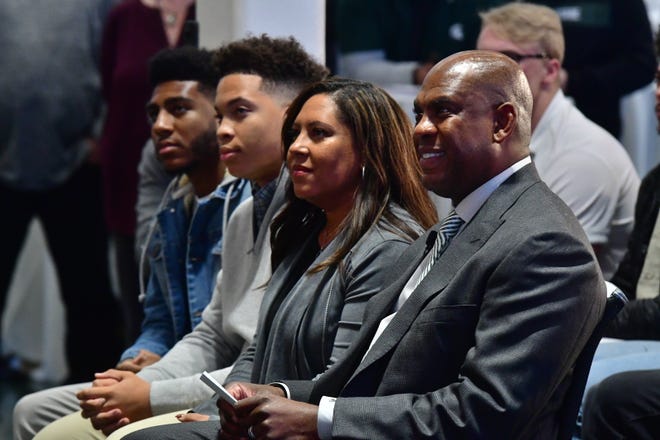 Mel Tucker, right, sits with his sons (from left) Joseph and Christian, and his wife Jo-Ellyn before being introduced as the next head football coach for Michigan State University