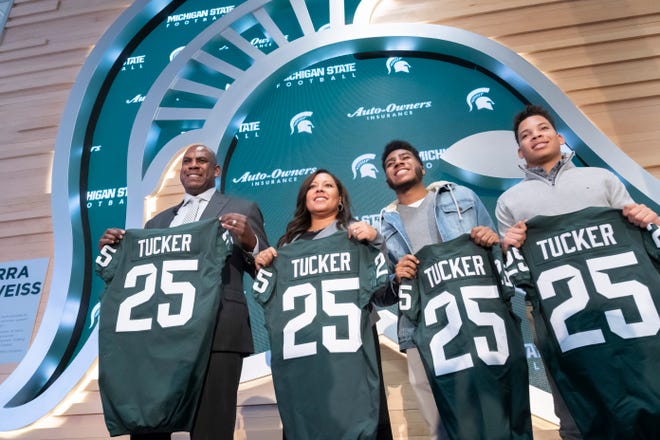 New MSU football coach Mel Tucker stands with (from left) his wife JoEllyn and sons Joseph and Christian.