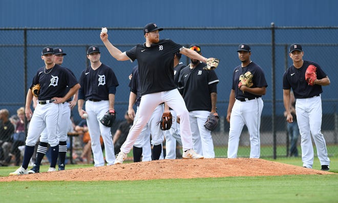 Tigers pitchers watch while Spencer Turnbull makes a throw to second after stepping off the mound.