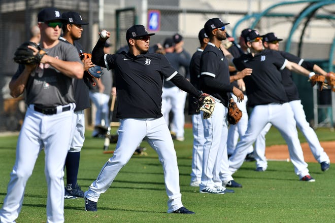 Tigers position players including Isaac Paredes, center left, warm up.