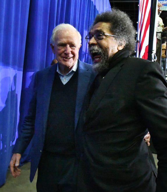Former Michigan Senator Donald Riegle walks out with political activist Cornel West after Sanders speech Friday night in Detroit.