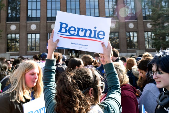 Aaryn Camacho of Toledo, Ohio holds up a Sanders sign to show her support for U.S. Senator and presidential candidate Bernie Sanders, Sunday, March 8, 2020 in Ann Arbor, Mich.