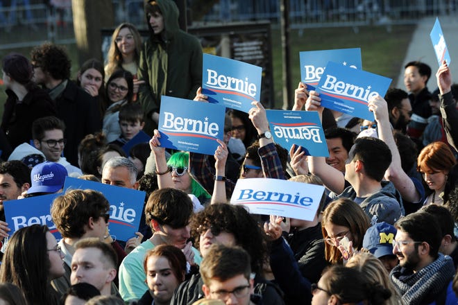 Supporters of U.S. Senator and presidential candidate Bernie Sanders wait for him to arrive and address the crowd on the campus of The University of Michigan, Sunday, March 8, 2020.