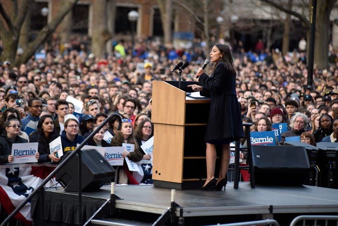 U.S. Representative Alexandria Ocasio-Cortez addresses the crowd before U.S. Senator and presidential candidate Bernie Sanders came on stage on the campus of The University of Michigan, Sunday, March 8, 2020 in Ann Arbor, Mich.
