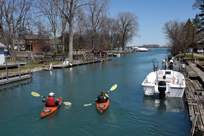 Kayakers paddle their way around Elba Island and towards the Detroit River, Mich., Friday, April 3, 2020.
