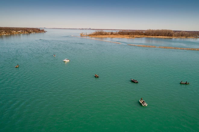 Fishermen ply the Detroit River in search of walleye near Grosse Ile, Mich., Friday, April 3, 2020.