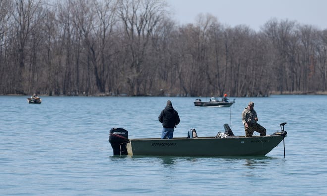 Fishermen ply the Trenton Channel of the Detroit River in search of walleye near Trenton, Mich., Friday, April 3, 2020.