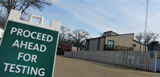 A sign at a drive-thru COVID-19 testing location in Lansing tells drivers to "proceed ahead." No testing appeared to be occurring at the site on Tuesday morning, April 14, 2020.