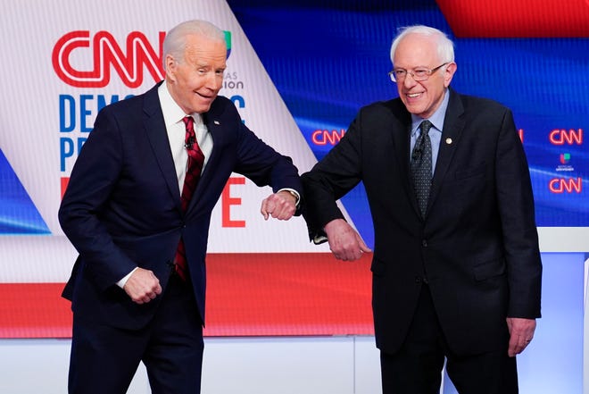 Former Vice President Joe Biden, left, will let Sen. Bernie Sanders, I-Vt., right, keep his delegates at the convention though Sanders has dropped out of the Democratic presidential primary race.
