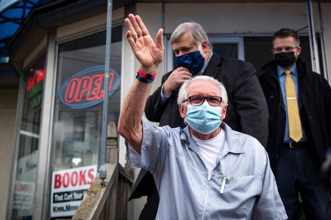 Karl Manke, 77, waves to supporters outside of his barbershop on West Main Street in Owosso Monday. Manke opened his barbershop and has hired Kallman Legal Group as his legal counsel because he was charged with criminal misdemeanor violations for allegedly violating Gov. Gretchen Whitmer’s executive orders.