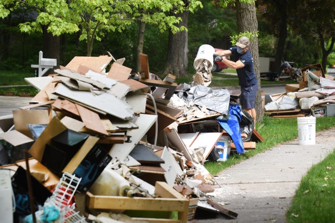 Work continues as the massive clean up due to flooding  last week in Midland along Woodbridge Lane on Wednesday, May 27, 2020