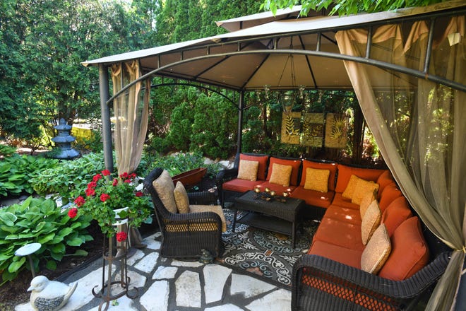 A gazebo seating area is another seating area. Art panels are suspended from one side.