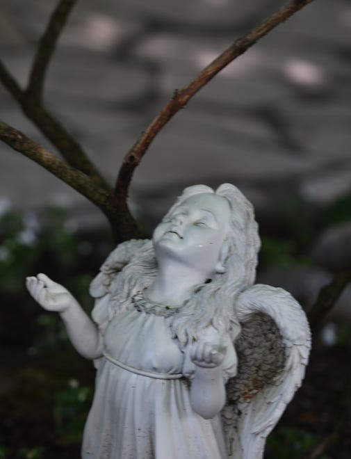 An angel statue with her hands open also is a tribute to Kathy ' s parents.