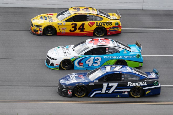 Michael McDowell (34), Bubba Wallace (43) and Chris Buescher (17) ride side-by-side during Monday's race.