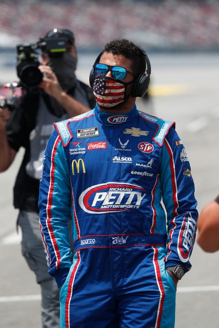 Bubba Wallace walks to his car in the pits.