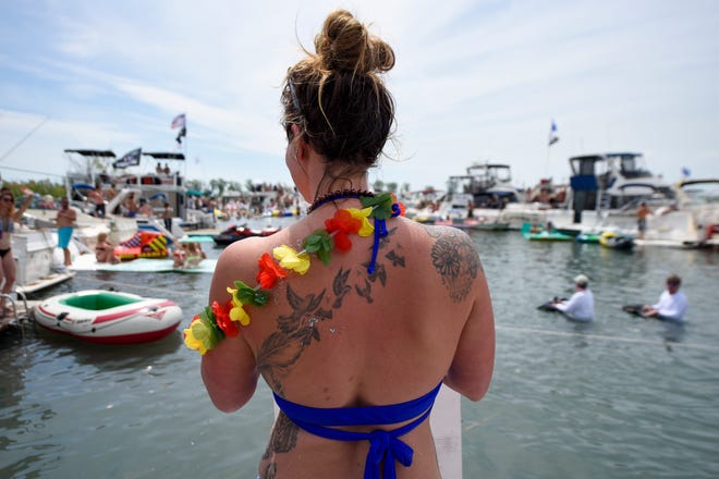 A woman surveys the crowd during the annual Jobbie Nooner at Gull Island on Lake St. Clair, Friday, June 26, 2020.