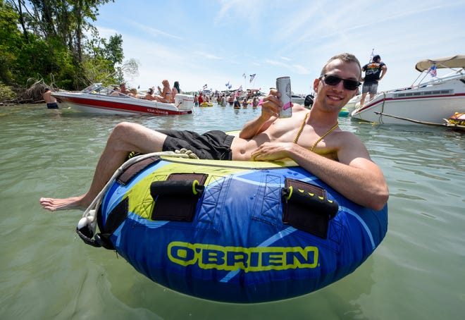 Kyle Janulis, Macomb Township, enjoys a float and a drink during the annual Jobbie Nooner at Gull Island on Lake St. Clair, Friday, June 26, 2020. Kyle janulis, Macomb township.