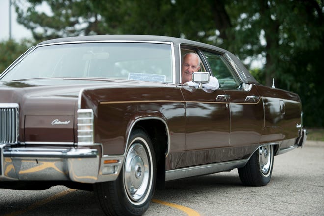 Dennis Garrett, a sales consultant at Hines Park Lincoln in Plymouth shows off his 1974 Lincoln Town Car Continental, August 10, 2015.