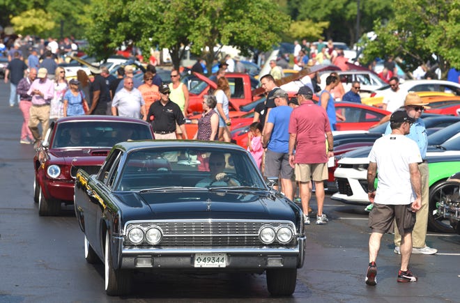 John Standhardt, of Livonia, drives his 1962 Lincoln Continental past the crowd at the 41st Annual Concours d'Elegance of America at the Inn at St. John's in Plymouth, July 27, 2019.