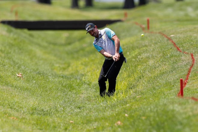 Rory Sabbatini hits from a hazard on the 18th hole.