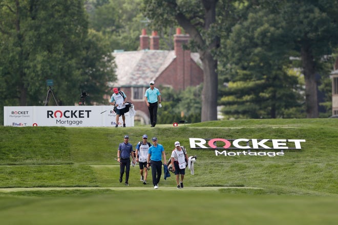 Matt Wallace, front, Sam Ryder, center, and John Senden walk on the ninth fairway during the first round of the Rocket Mortgage Classic
