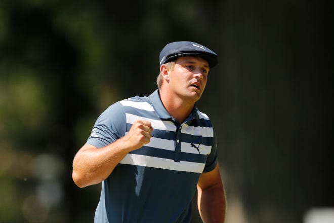 Bryson DeChambeau pumps his fist after a birdie putt on the 10th green.