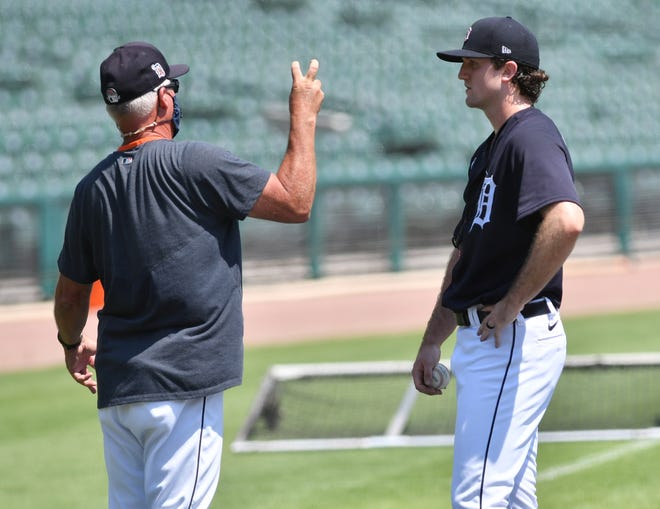 From left, Tigers pitching coach Rick Anderson talks with pitcher Casey Mize after Mize threw live batting practice.  Detroit Tigers work out at Comerica Park in Detroit on July 6, 2020.
