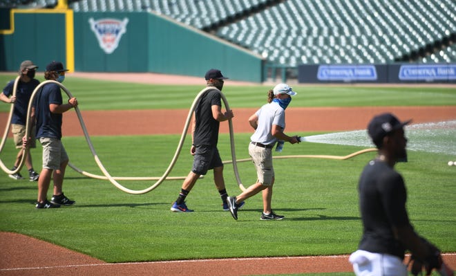 The grounds crew sprays the infield between groups of players working out.  Detroit Tigers work out at Comerica Park in Detroit on July 6, 2020.