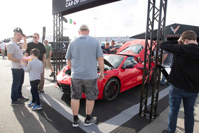 Fans gather around a production Corvette C8 at Daytona in January 2020. The C8.R race car raced to 4th and 7th place at the Rolex 24 Hours of Daytona.