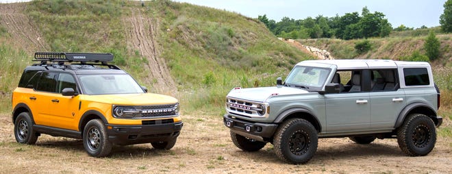 The 2021 Ford Bronco Sport, left, and Bronco four-door are pictured together at the Holly Oaks ORV Park on Friday.