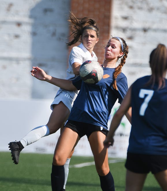 Livonia City FC's Adriana Mroz settles the ball in front of Midwest United FC's Mary Dzuiba in the first half.