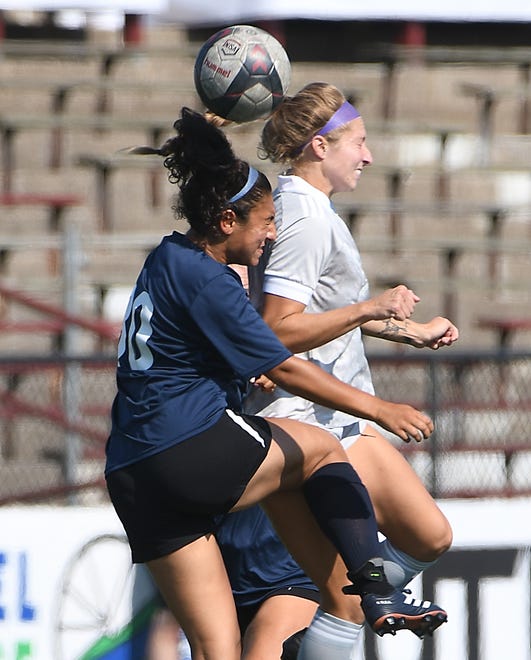 Livonia City FC's Maddy Mosallam and Midwest United FC's Katie Vitella go up for a ball in the first half.