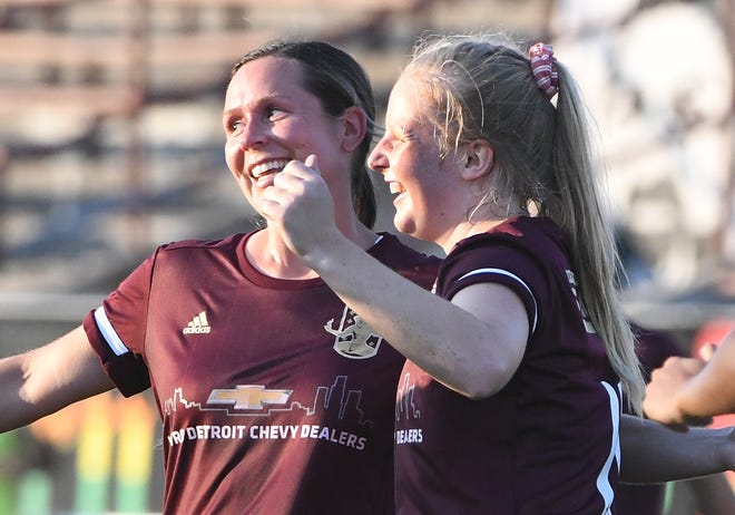 Detroit City FC players gather around Lilian Lucas, right, after scoring DCFC women's first home goal in the first half.